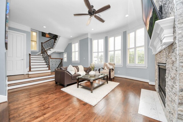 2008 Helena St, Houston, TX 77002 - living area featuring a stone fireplace, plenty of natural light, stairs, crown molding, and ceiling fan