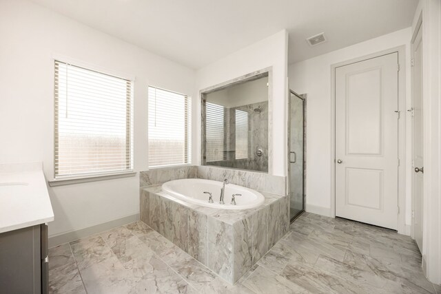 2326 Bristlegrass Dr, Katy, TX 77494 - bathroom featuring marble look tiles, vanity, baseboards, and a garden tub