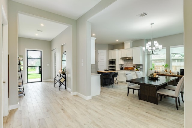 9715 Highland Pointe Dr, Needville, TX 77461 - dining room with a chandelier, light wood finished floors, baseboards, and recessed lighting