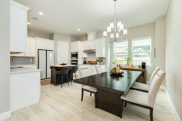 9715 Highland Pointe Dr, Needville, TX 77461 - dining space with a chandelier, light wood-style floors, baseboards, and recessed lighting