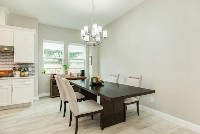 9715 Highland Pointe Dr, Needville, TX 77461 - dining space with a chandelier, light wood finished floors, and baseboards