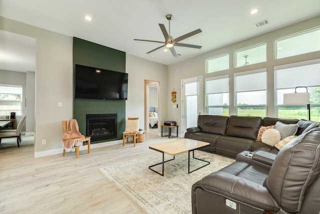 9715 Highland Pointe Dr, Needville, TX 77461 - living area featuring ceiling fan, light wood-type flooring, a fireplace, baseboards, and recessed lighting
