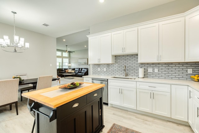 9715 Highland Pointe Dr, Needville, TX 77461 - kitchen featuring a sink, butcher block counters, stainless steel dishwasher, white cabinets, and recessed lighting