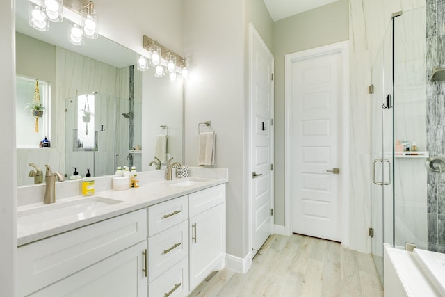 9715 Highland Pointe Dr, Needville, TX 77461 - bathroom with a shower stall, double vanity, wood finished floors, and a bathtub