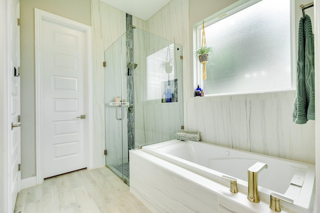 9715 Highland Pointe Dr, Needville, TX 77461 - bathroom with a shower stall, a bath, and wood finished floors
