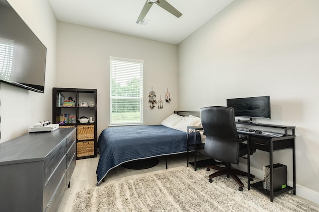9715 Highland Pointe Dr, Needville, TX 77461 - bedroom with light wood-style flooring, ceiling fan, baseboards, and an office area
