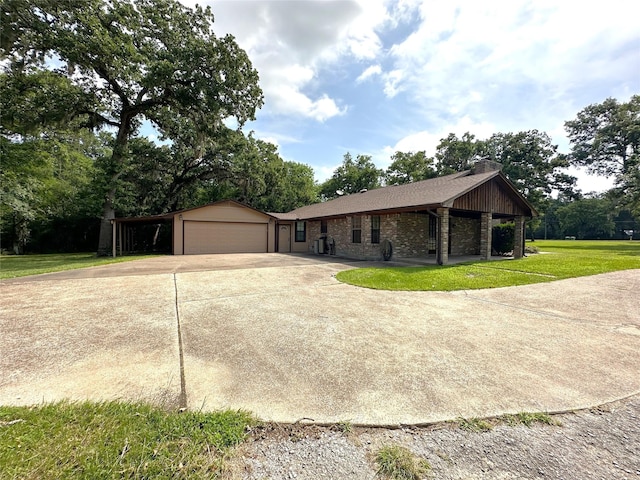 113 Fm 3454th Rd, Huntsville, TX 77320 - view of front of house with a chimney, a front yard, driveway, stone siding, and an outdoor structure