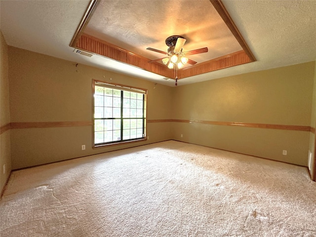 113 Fm 3454th Rd, Huntsville, TX 77320 - carpeted empty room with a textured ceiling, a tray ceiling, a ceiling fan, and baseboards