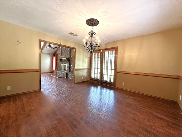 113 Fm 3454th Rd, Huntsville, TX 77320 - spare room with a chandelier, wood finished floors, a fireplace, and baseboards