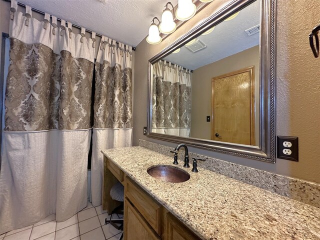 113 Fm 3454th Rd, Huntsville, TX 77320 - bathroom with tile patterned floors, vanity, and a textured ceiling