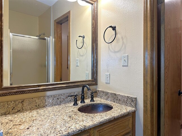 113 Fm 3454th Rd, Huntsville, TX 77320 - bathroom featuring vanity, a shower stall, and a textured wall