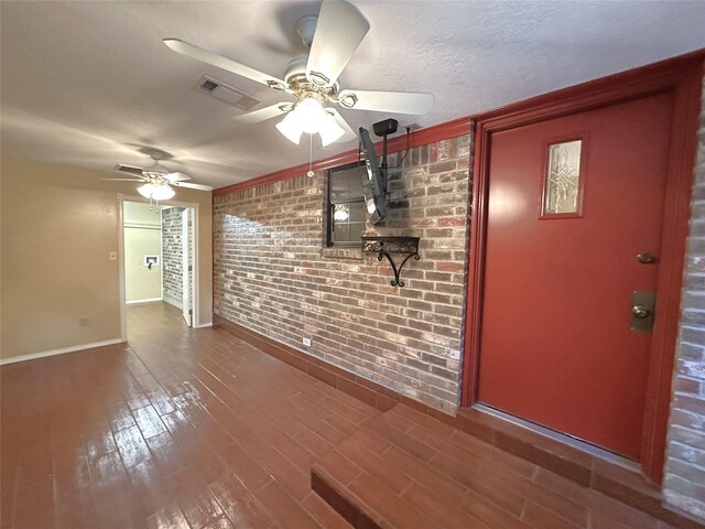 113 Fm 3454th Rd, Huntsville, TX 77320 - unfurnished living room featuring brick wall, a ceiling fan, baseboards, wood finished floors, and ornamental molding
