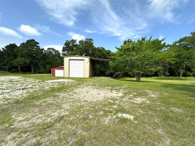 113 Fm 3454th Rd, Huntsville, TX 77320 - view of grassy yard featuring a garage and an outdoor structure