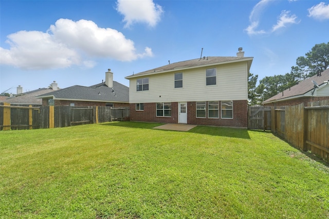 6419 Bonnie Chase Ln, Katy, TX 77449 - back of house featuring brick siding, a patio area, and a chimney