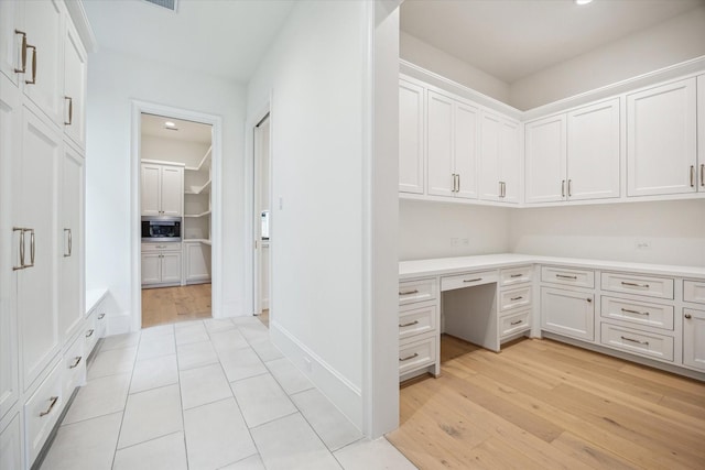 1016 Alexander St, Houston, TX 77008 - unfurnished office featuring light wood-style flooring, built in study area, and baseboards