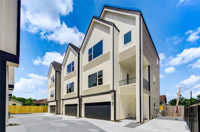 4045 Buck St, Houston, TX 77020 - view of front facade with board and batten siding, central AC unit, and a garage