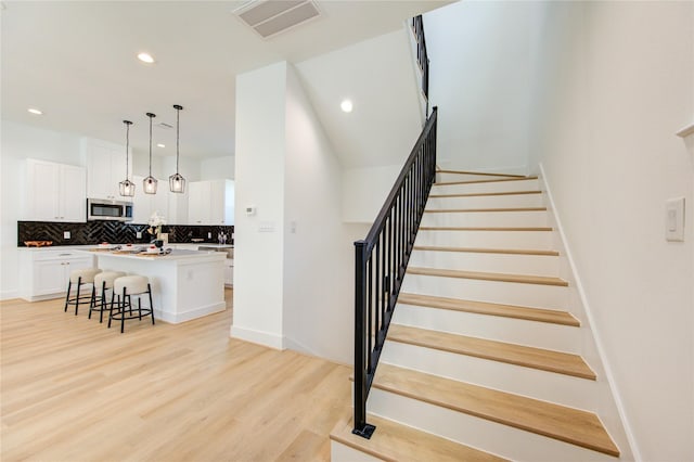 4045 Buck St, Houston, TX 77020 - stairs featuring recessed lighting and wood finished floors