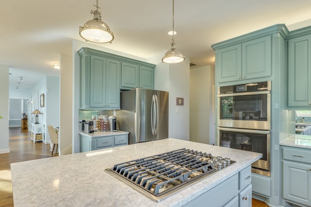 4315 Lago Viento, Austin, TX 78734 - kitchen featuring appliances with stainless steel finishes, wood finished floors, pendant lighting, and baseboards