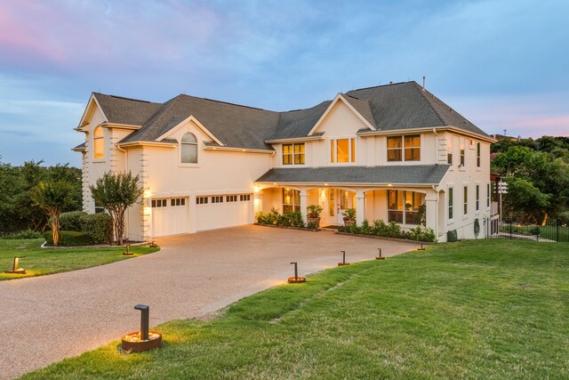 4315 Lago Viento, Austin, TX 78734 - view of front of home with an attached garage, driveway, a front lawn, and covered porch