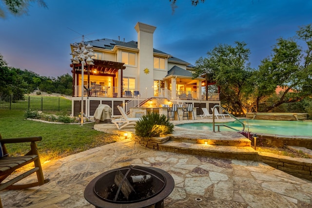 4315 Lago Viento, Austin, TX 78734 - back of house featuring a fire pit, stairway, a patio area, solar panels, and an outdoor pool