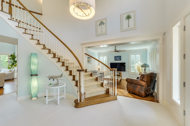 4315 Lago Viento, Austin, TX 78734 - stairs with healthy amount of natural light, a towering ceiling, ornamental molding, baseboards, and a fireplace