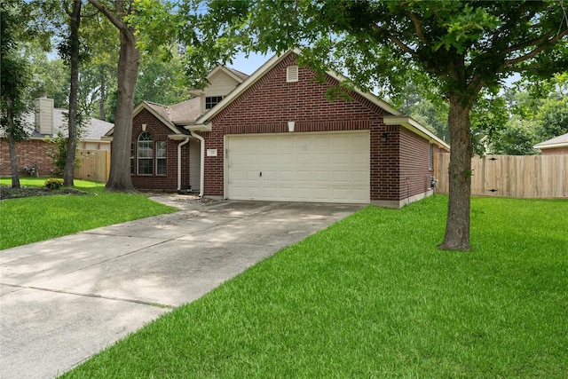 23 Drifting Shadows Cir, Conroe, TX 77385 - traditional home with a garage, brick siding, and driveway