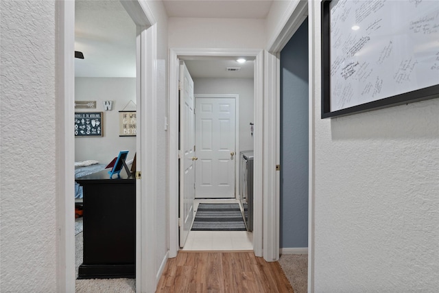 23 Drifting Shadows Cir, Conroe, TX 77385 - corridor with wood finished floors, baseboards, and a textured wall