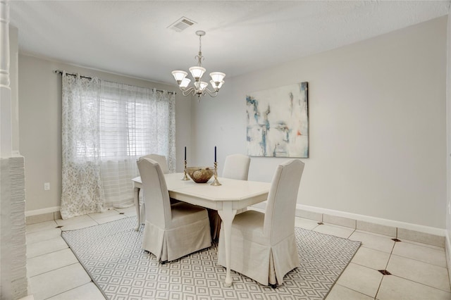 9327 Fairdale Ln, Houston, TX 77063 - dining space with a chandelier, light tile patterned flooring, and baseboards