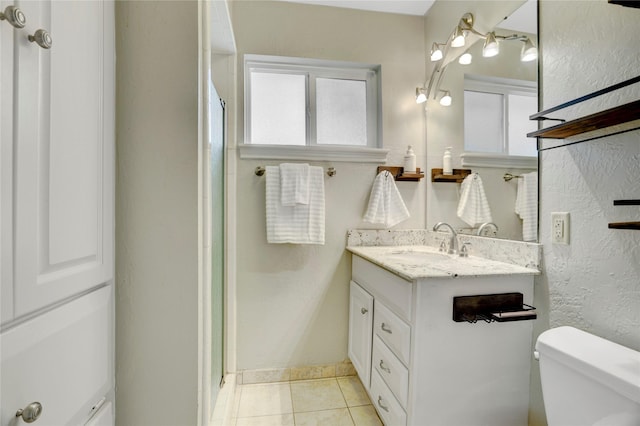 9327 Fairdale Ln, Houston, TX 77063 - bathroom featuring vanity, toilet, tile patterned floors, an enclosed shower, and a textured wall