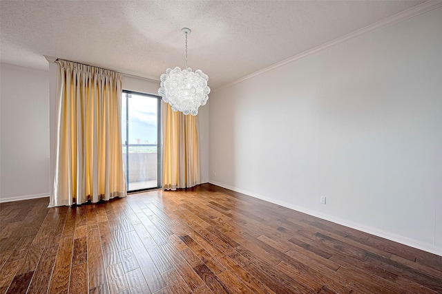 651 Bering Dr Unit 1101, Houston, TX 77057 - unfurnished room with a chandelier, dark wood-style floors, a textured ceiling, ornamental molding, and baseboards