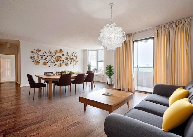651 Bering Dr Unit 1101, Houston, TX 77057 - living area featuring a textured ceiling, a chandelier, and wood finished floors