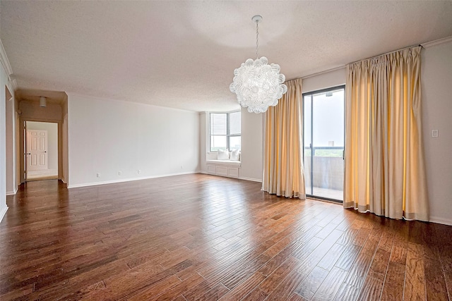 651 Bering Dr Unit 1101, Houston, TX 77057 - spare room featuring a chandelier, dark wood-style floors, a textured ceiling, and baseboards
