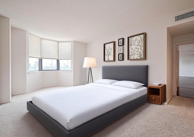 651 Bering Dr Unit 1101, Houston, TX 77057 - carpeted bedroom with a textured ceiling