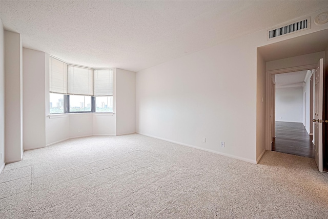 651 Bering Dr Unit 1101, Houston, TX 77057 - carpeted spare room featuring a textured ceiling and baseboards