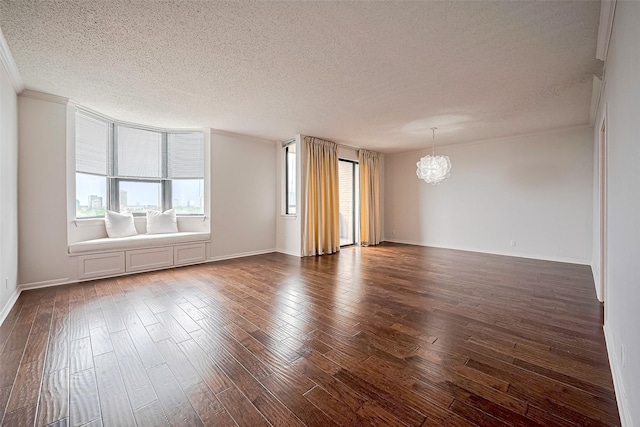 651 Bering Dr Unit 1101, Houston, TX 77057 - spare room with a textured ceiling, a chandelier, dark wood-style flooring, ornamental molding, and baseboards