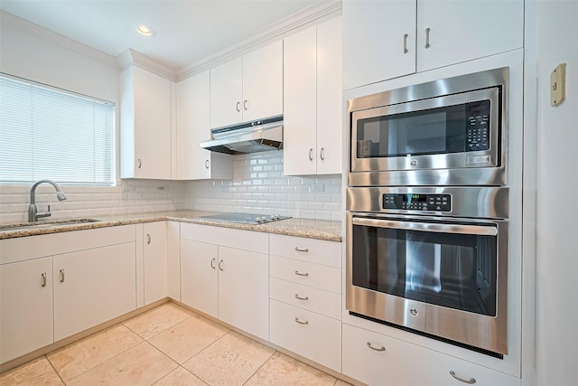 651 Bering Dr Unit 1101, Houston, TX 77057 - kitchen with stainless steel appliances, a sink, under cabinet range hood, tasteful backsplash, and ornamental molding
