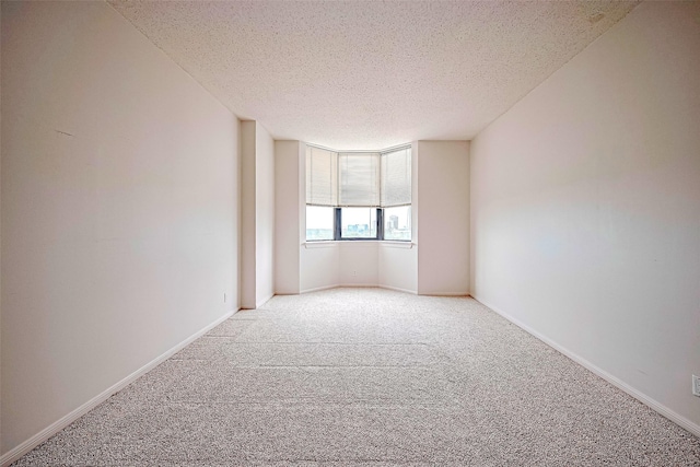 651 Bering Dr Unit 1101, Houston, TX 77057 - empty room featuring light carpet, a textured ceiling, and baseboards