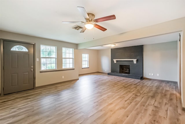 3313 Chestershire Dr, Pasadena, TX 77503 - unfurnished living room featuring light wood-style floors, ceiling fan, a fireplace, and baseboards