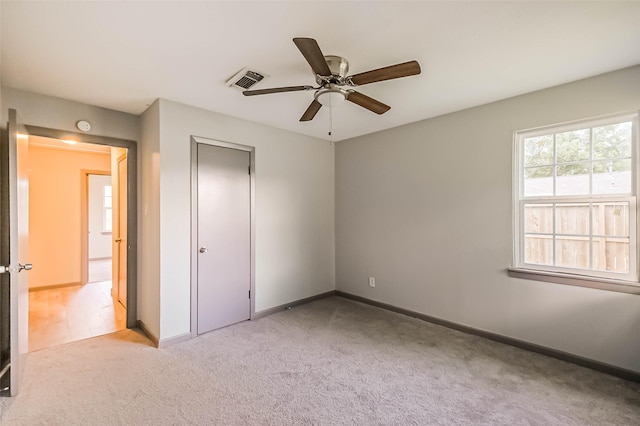 3313 Chestershire Dr, Pasadena, TX 77503 - unfurnished bedroom with light colored carpet, baseboards, ceiling fan, and a closet