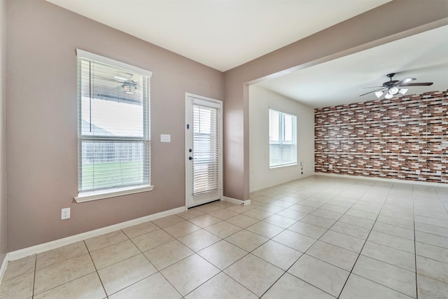 21114 Echo Manor Dr, Hockley, TX 77447 - foyer with a ceiling fan, light tile patterned floors, and brick wall