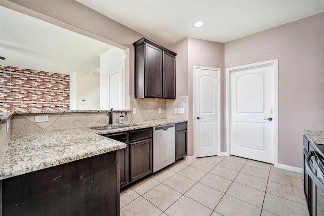 21114 Echo Manor Dr, Hockley, TX 77447 - kitchen with stainless steel dishwasher, dark brown cabinets, decorative backsplash, and light stone countertops
