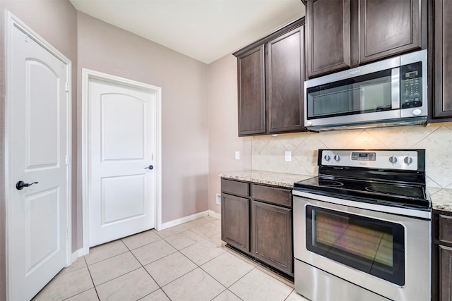 21114 Echo Manor Dr, Hockley, TX 77447 - kitchen featuring stainless steel appliances, dark brown cabinets, backsplash, and light stone countertops