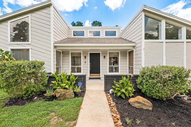 44 Foy Martin Dr, Conroe, TX 77304 - mid-century modern home featuring a porch and a shingled roof