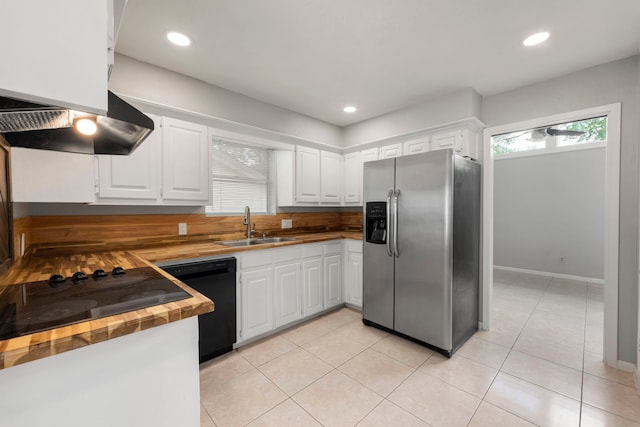 44 Foy Martin Dr, Conroe, TX 77304 - kitchen with black appliances, butcher block countertops, healthy amount of natural light, white cabinetry, and recessed lighting