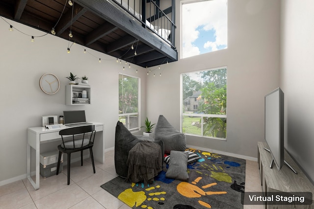 44 Foy Martin Dr, Conroe, TX 77304 - home office featuring light tile patterned floors, a towering ceiling, and beam ceiling