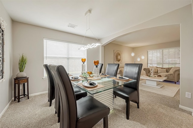 3126 Silverstag Trail Ln, Houston, TX 77073 - dining space featuring light carpet, arched walkways, and baseboards