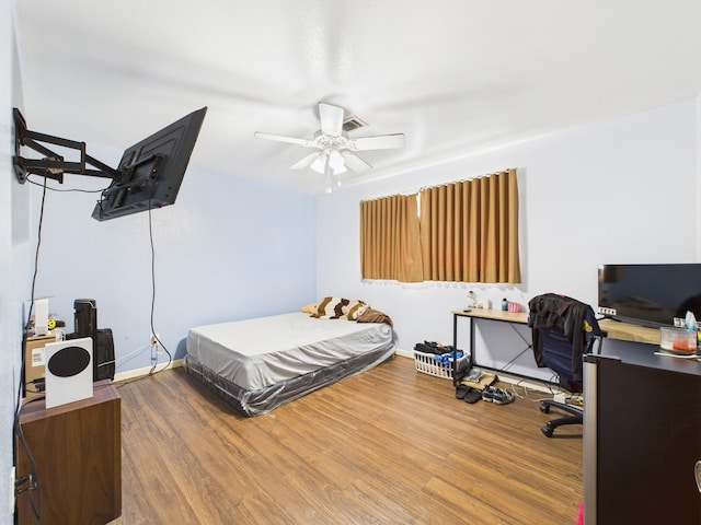 8206 Dillon St, Houston, TX 77061 - bedroom with wood finished floors, a desk, baseboards, and ceiling fan