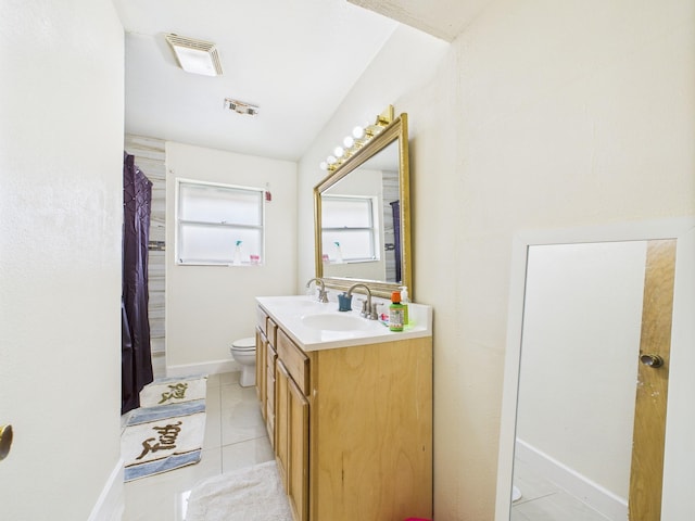 8206 Dillon St, Houston, TX 77061 - full bathroom featuring toilet, double vanity, tile patterned flooring, and baseboards
