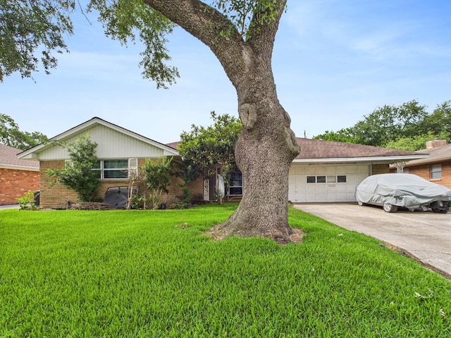 8206 Dillon St, Houston, TX 77061 - view of front facade with brick siding, driveway, a front lawn, and a garage