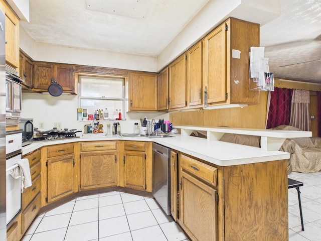 8206 Dillon St, Houston, TX 77061 - kitchen featuring a peninsula, appliances with stainless steel finishes, a kitchen breakfast bar, a sink, and light tile patterned floors